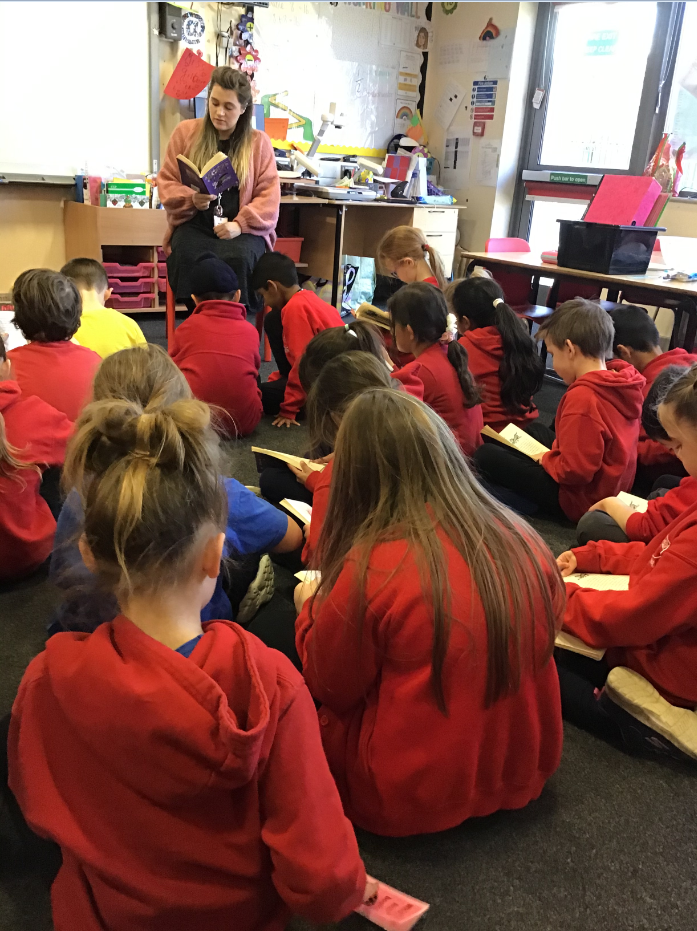 A teacher sharing a story with their class.