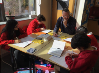 A teacher working with a group of children.