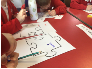 Children decorating jigsaw puzzle pieces to represent themselves & show how they are part of one big Service Family
