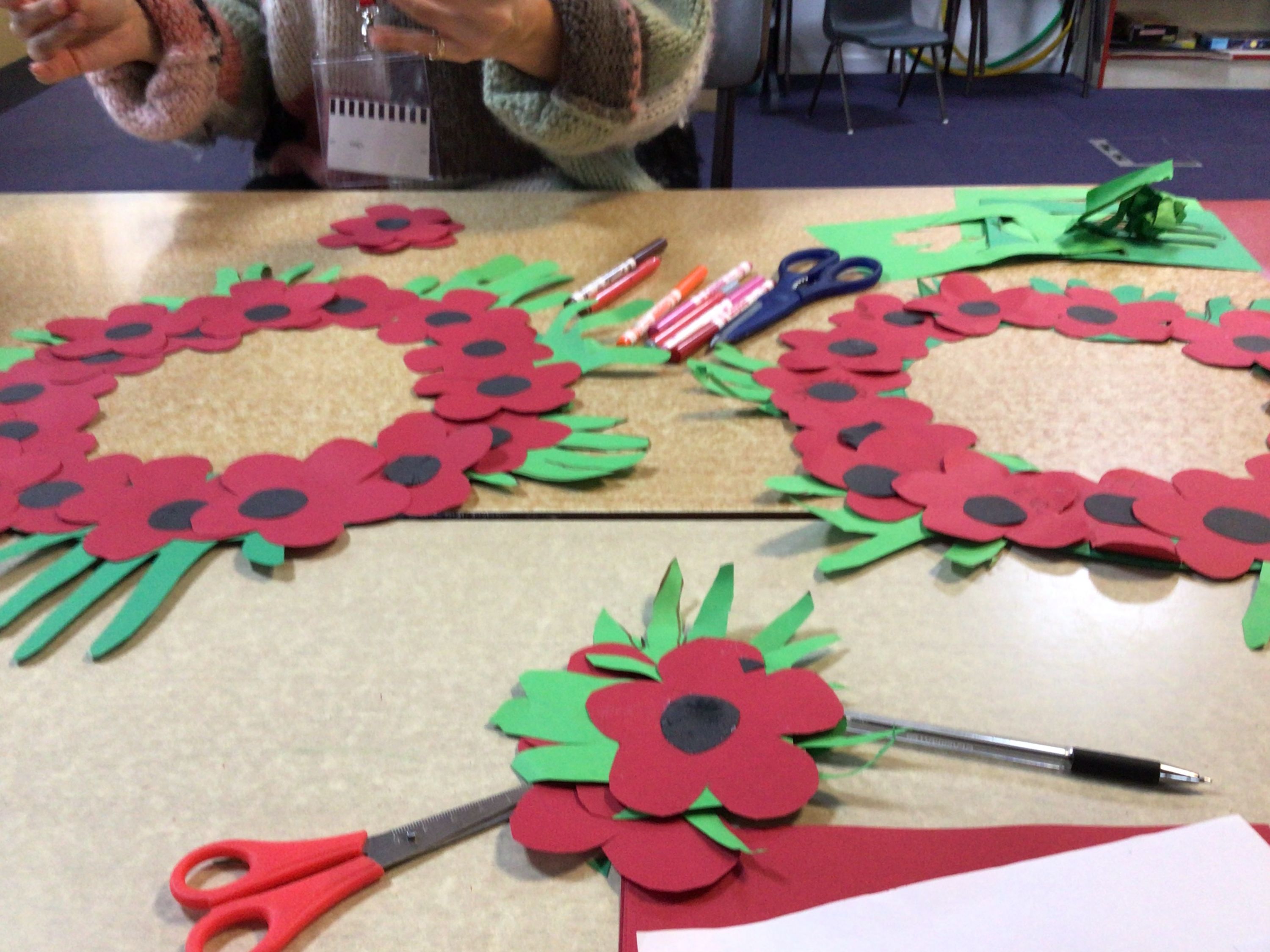 Children making poppy wreaths